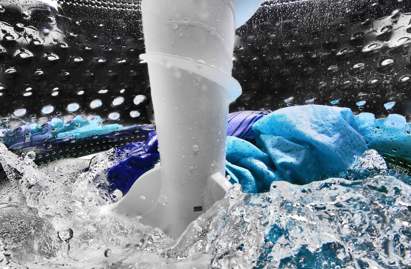Clothing agitating inside of the washer with water Clothing agitating inside of the washer with water