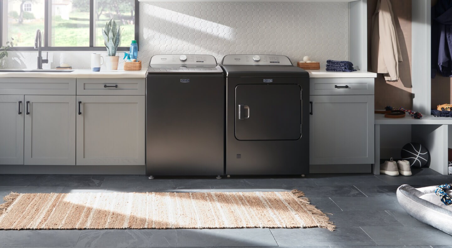 Maytag® top load washer and dryer pair in off-white cabinetry