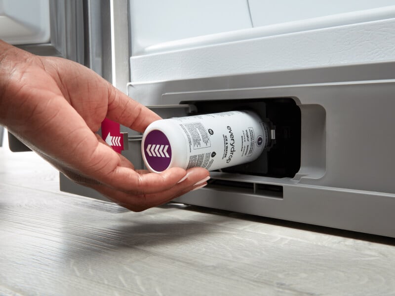 Person inserting an everydrop® water filter into their refrigerator Person inserting an everydrop® water filter into their refrigerator