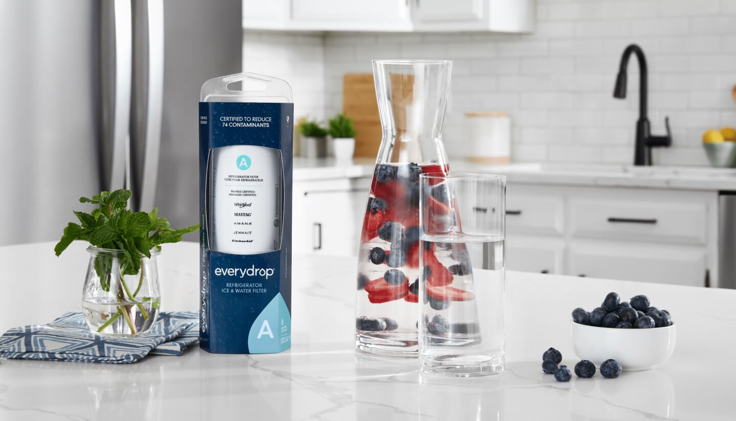 An everydrop® water filter on a kitchen counter next to a glass of water An everydrop® water filter on a kitchen counter next to a glass of water