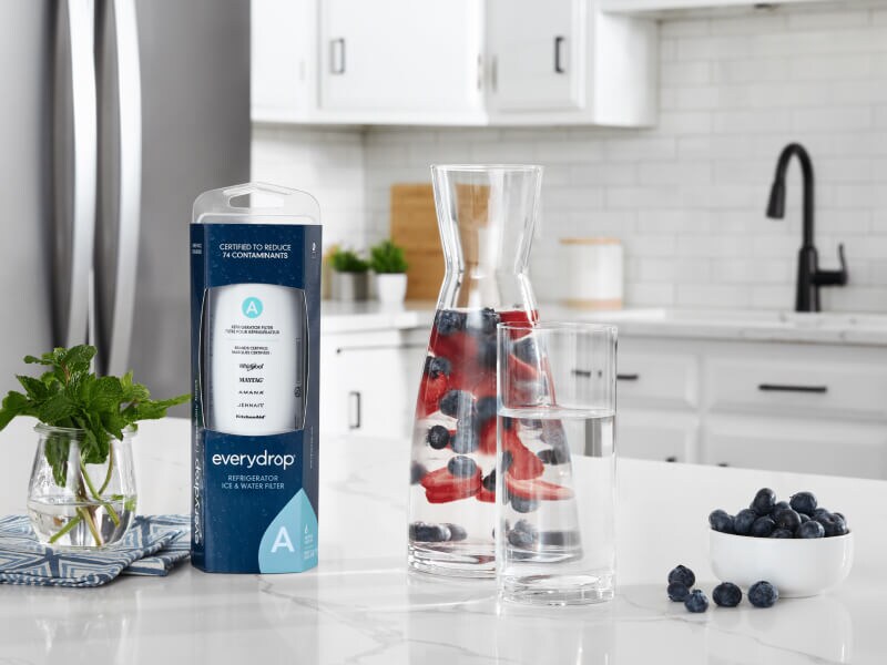 An everydrop® water filter on a kitchen counter next to a glass of water An everydrop® water filter on a kitchen counter next to a glass of water