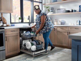 Person loading dishes in a dishwasher