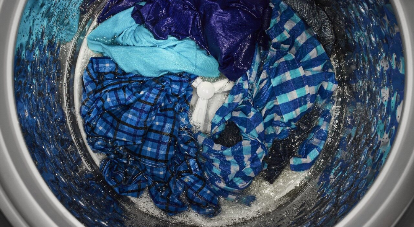 Blue clothes in the bottom of an impeller washer