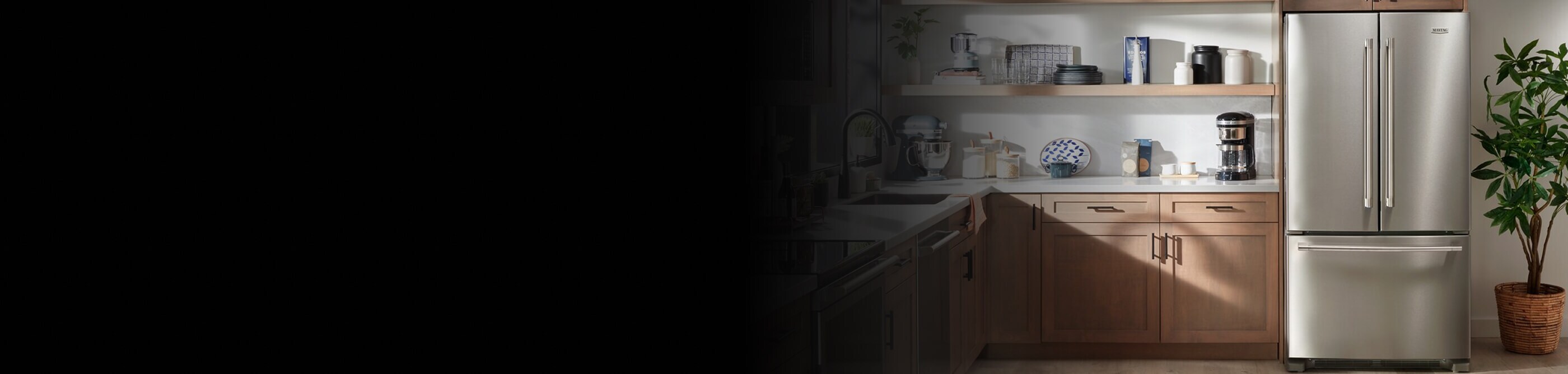 Stainless steel Maytag® French Door Refrigerator next to house plant