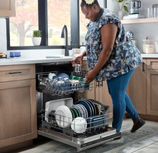 Person loading a dishwasher