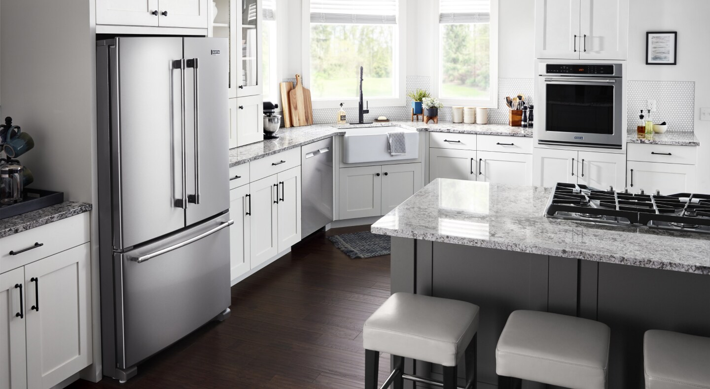 Kitchen with white cabinetry and granite countertops with stainless steel appliances Kitchen with white cabinetry and granite countertops with stainless steel appliances