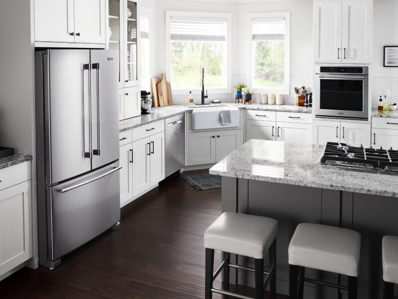 Kitchen with white cabinetry and granite countertops with stainless steel appliances Kitchen with white cabinetry and granite countertops with stainless steel appliances