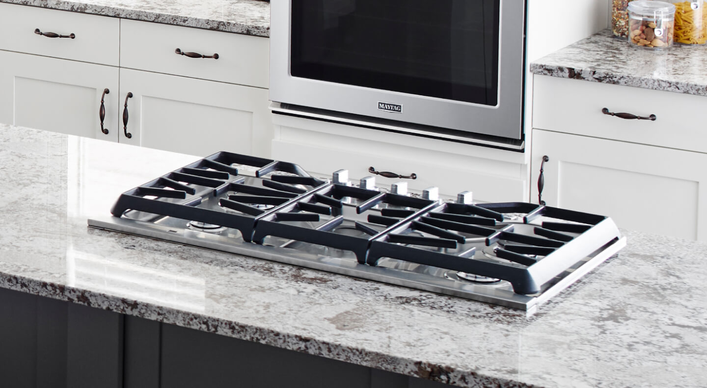 Maytag® gas cooktop on a kitchen island