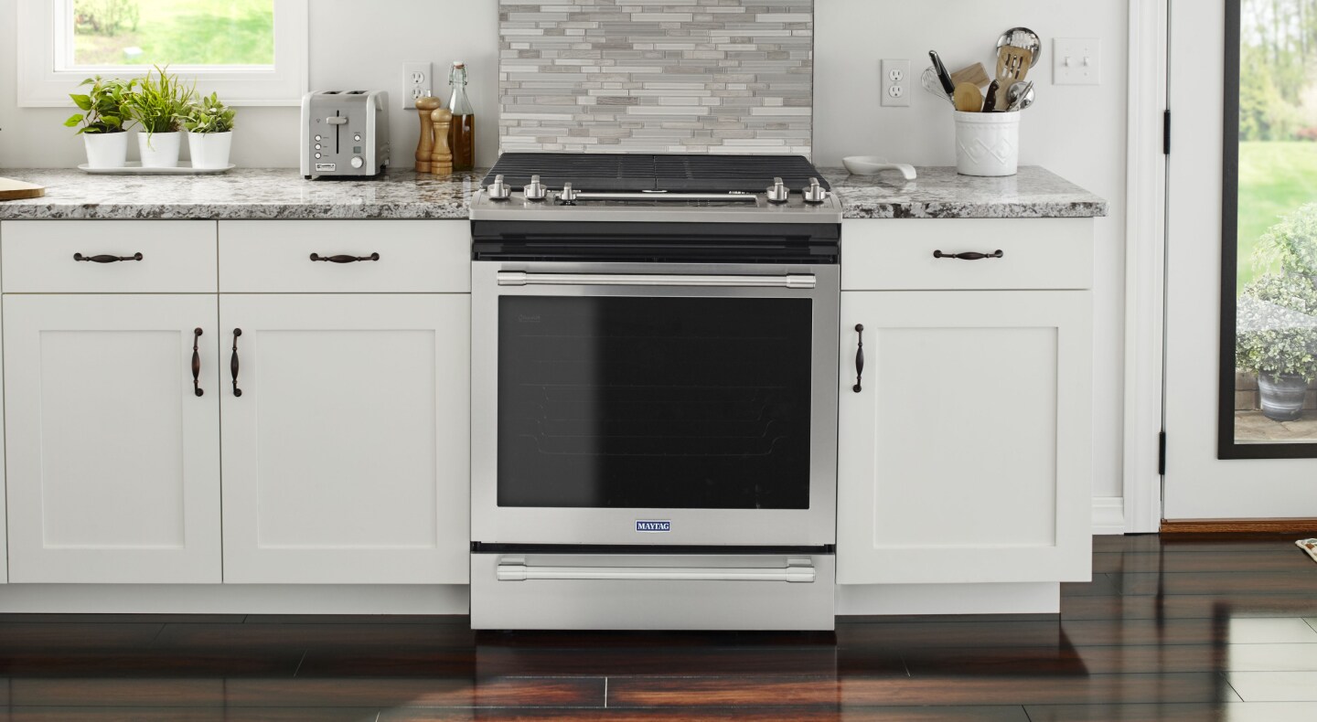 A stainless steel oven surrounded by white cabinetry A stainless steel oven surrounded by white cabinetry