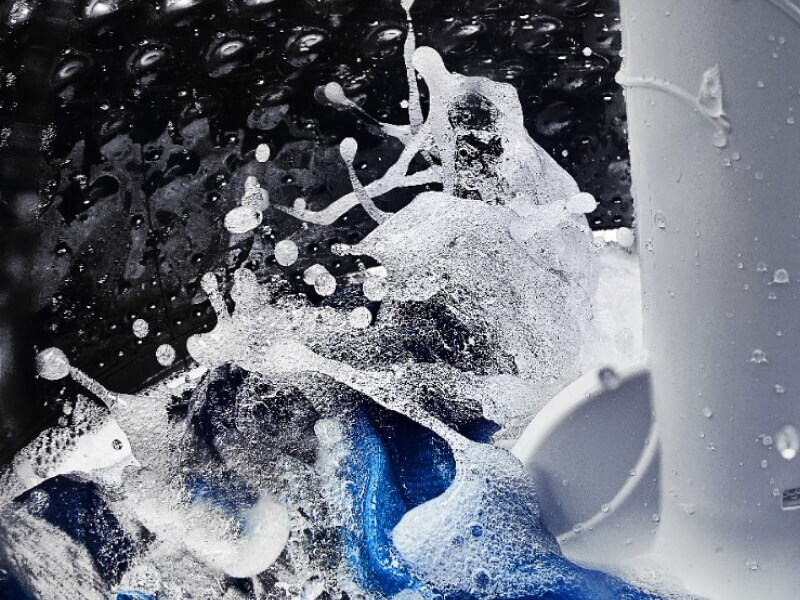 A close-up of the interior of a Maytag® washer tub with water