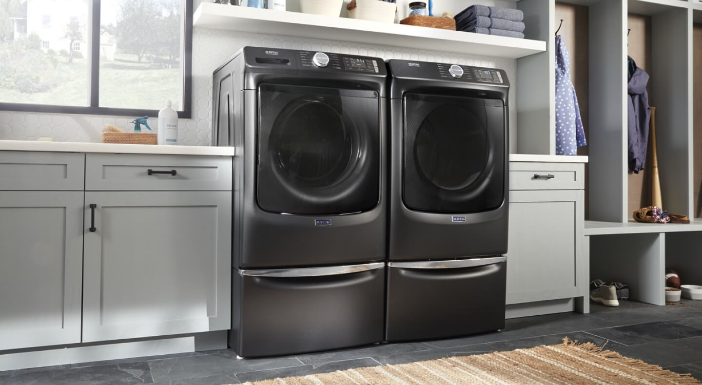 A side-by-side Maytag® front load washer and dryer in a modern laundry room