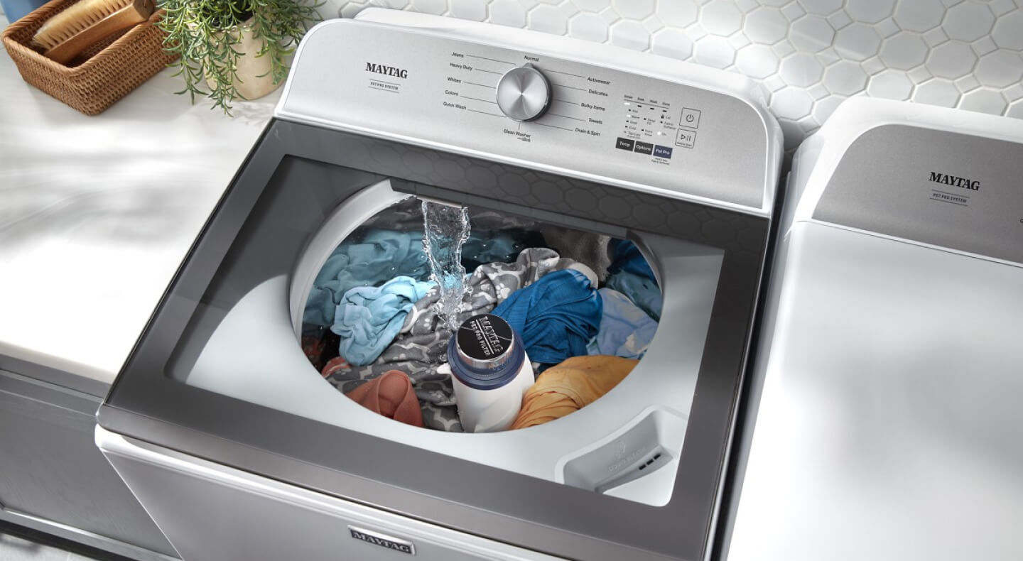 An overhead view of a Maytag® washing machine filling with water An overhead view of a Maytag® washing machine filling with water
