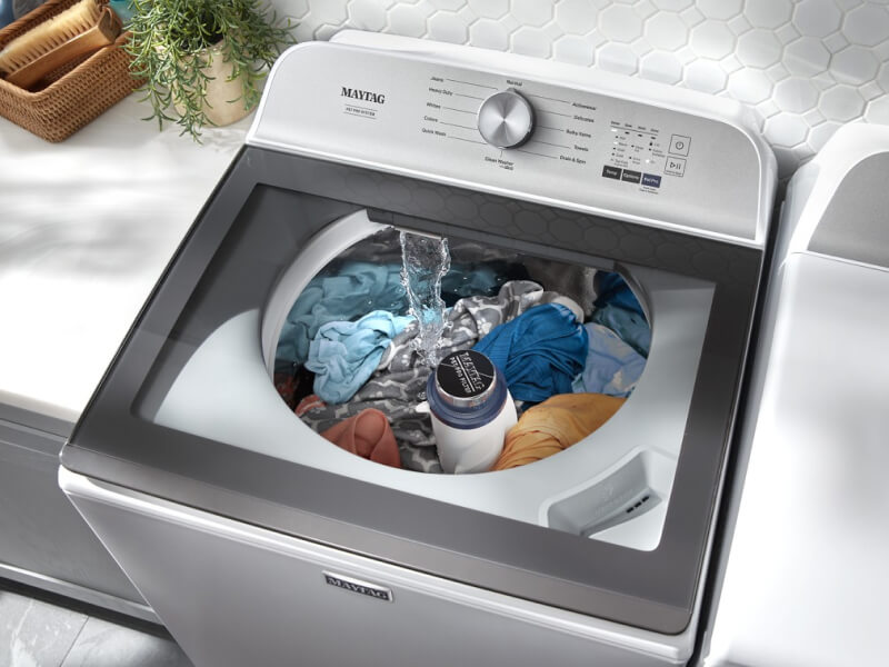 An overhead view of a Maytag® washing machine filling with water An overhead view of a Maytag® washing machine filling with water