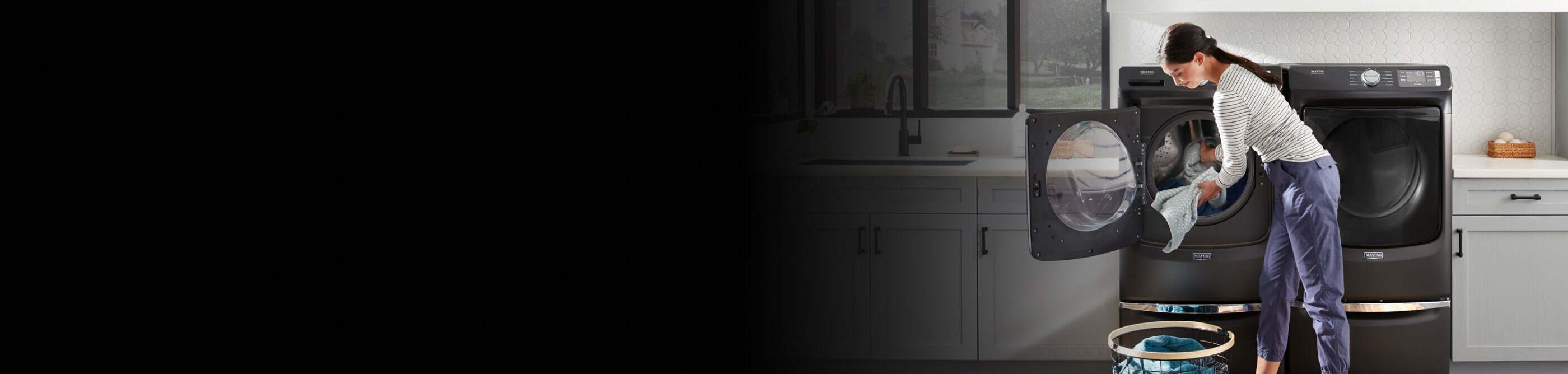Person doing laundry with a Maytag® washing machine