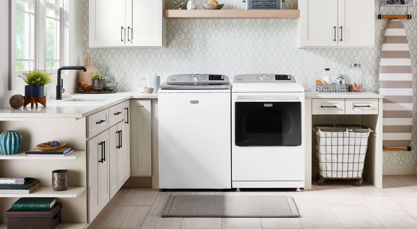 White Maytag® washer and dryer pair in a modern laundry room