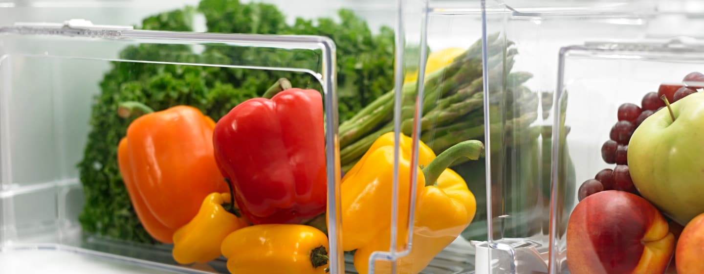 Peppers, asparagus and leafy greens stored in a crisper drawer Peppers, asparagus and leafy greens stored in a crisper drawer