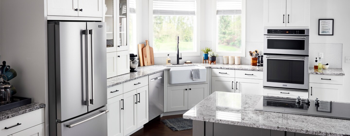 Kitchen with stainless steel appliances, white cabinetry and a kitchen island Kitchen with stainless steel appliances, white cabinetry and a kitchen island