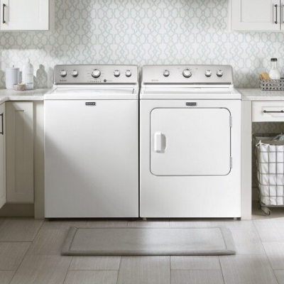 White Maytag® top load washer and dryer set in laundry room
