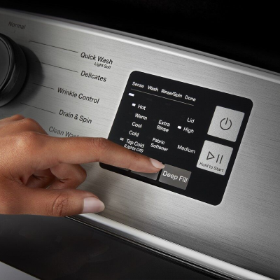 Close-up of person selecting washer cycle settings