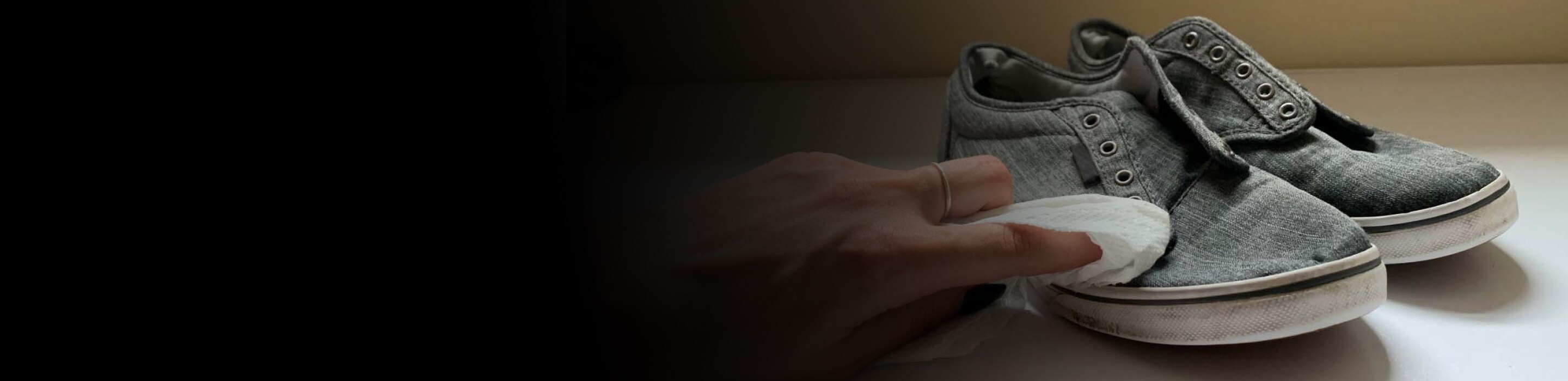 Close up of hand wiping dirty shoes