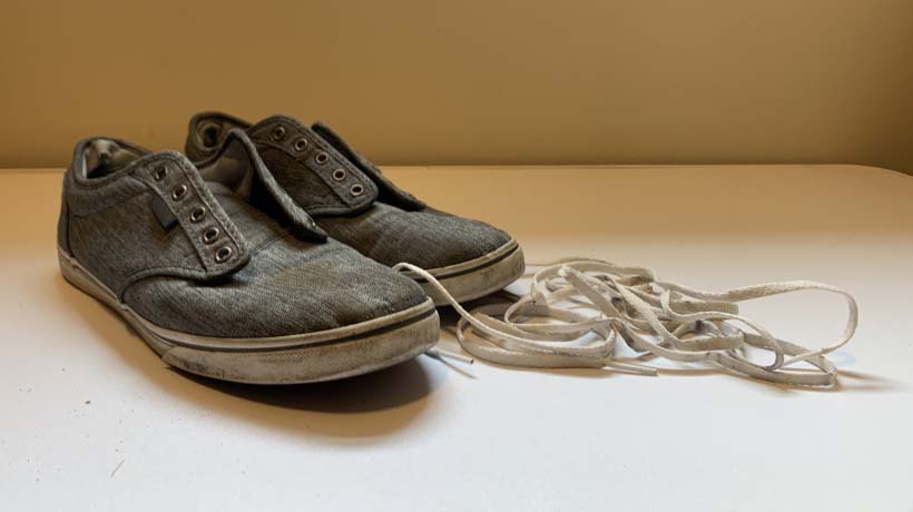 Dirty shoes with shoe laces removed