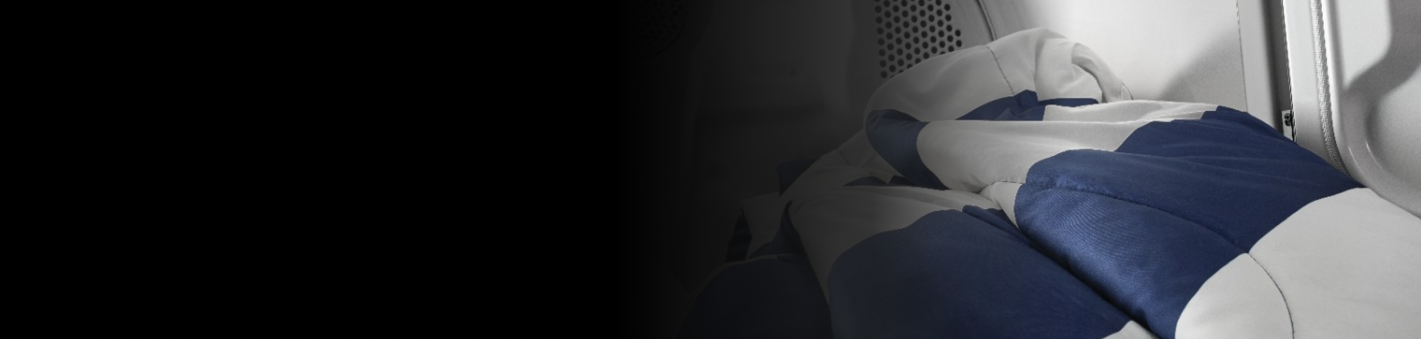 White and blue comforter inside of dryer drum