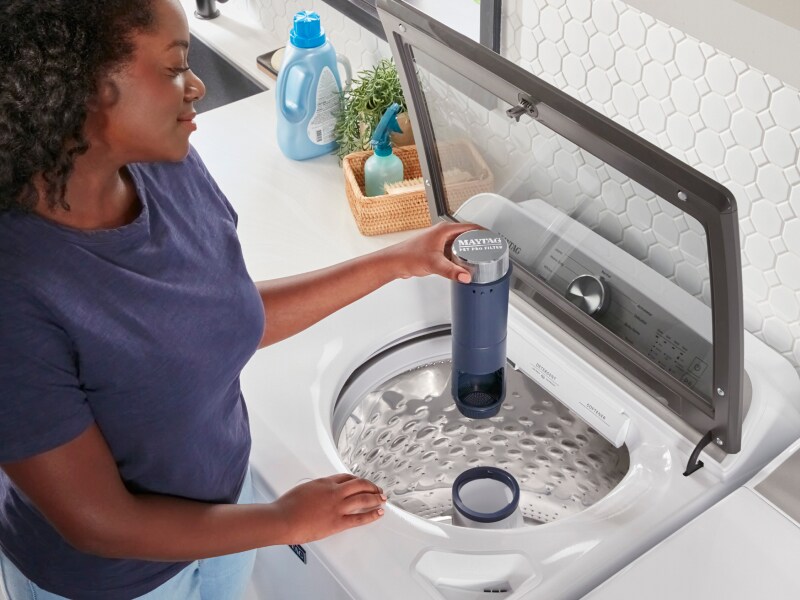 Person removing Maytag® Pet Pro Filter Person removing Maytag® Pet Pro Filter
