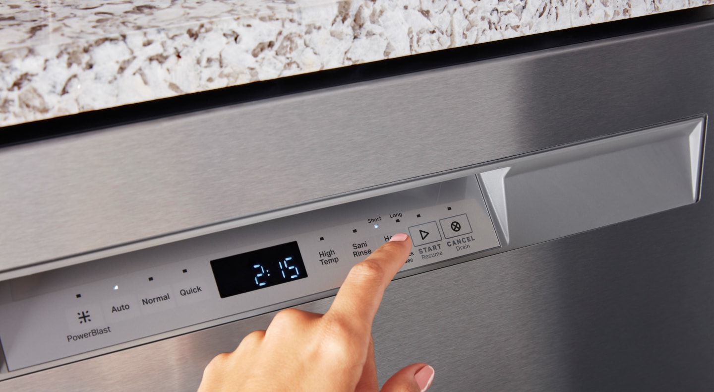 Person selecting a wash cycle on a Maytag® dishwasher Person selecting a wash cycle on a Maytag® dishwasher