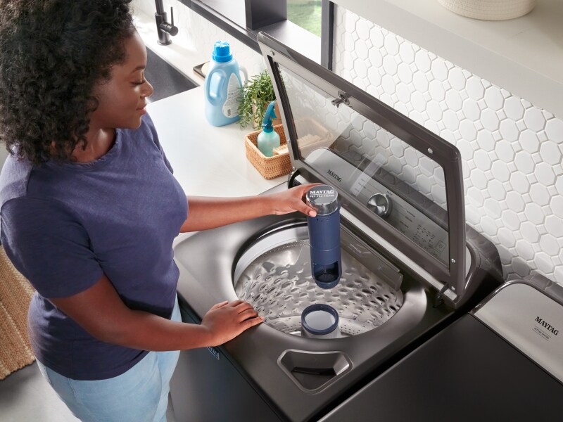 Person loading adding Pet Pro Filter to Maytag® washer Person loading adding Pet Pro Filter to Maytag® washer