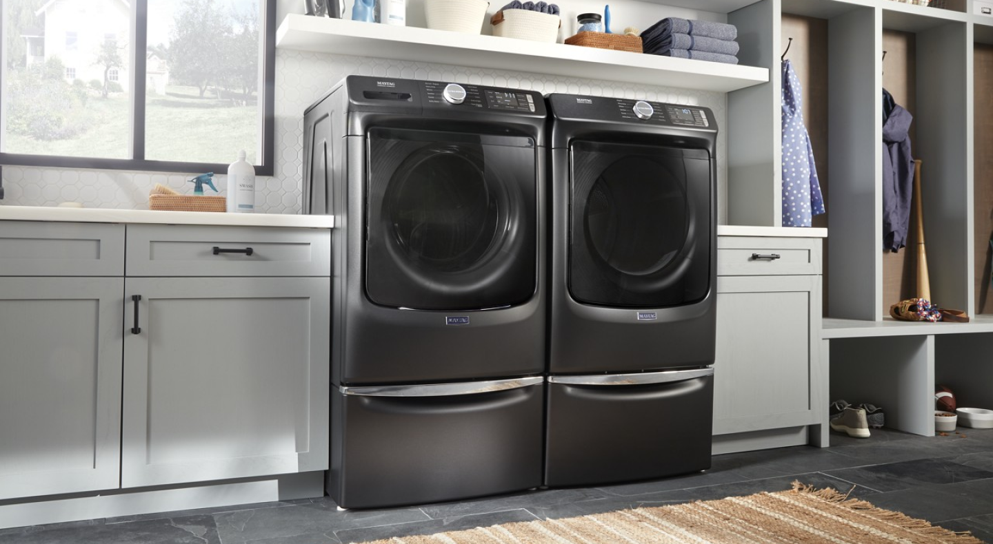 A black Maytag® front load washer and dryer set in a modern laundry room. A black Maytag® front load washer and dryer set in a modern laundry room.