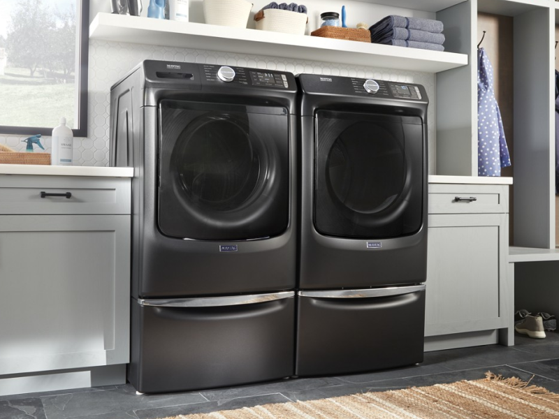 A black Maytag® front load washer and dryer set in a modern laundry room. A black Maytag® front load washer and dryer set in a modern laundry room.