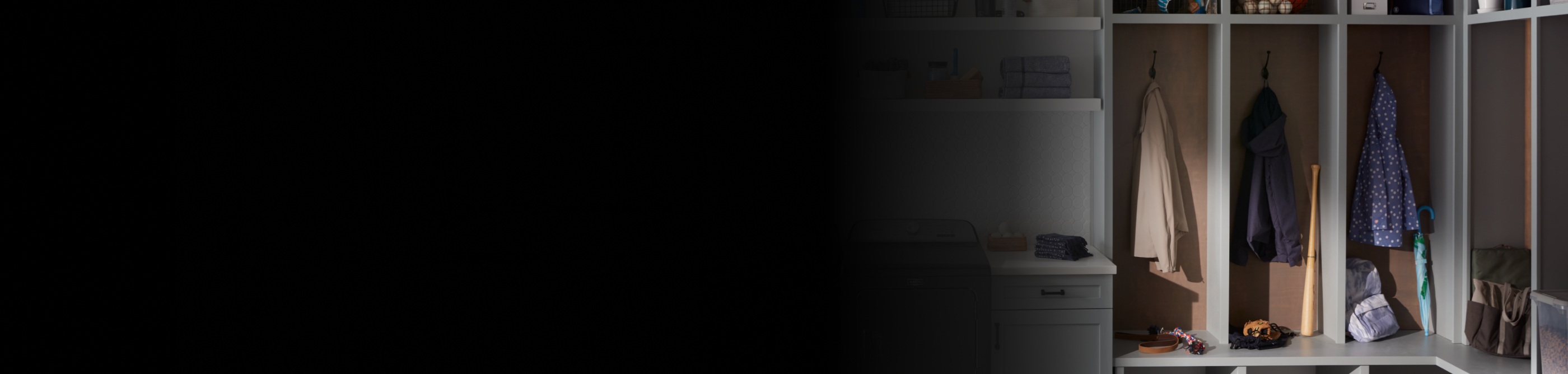 A modern mudroom with jackets hanging from hooks. 