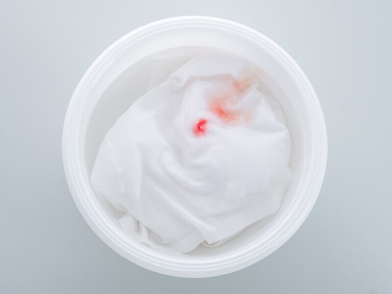 A closeup of a blood stain soaking in water