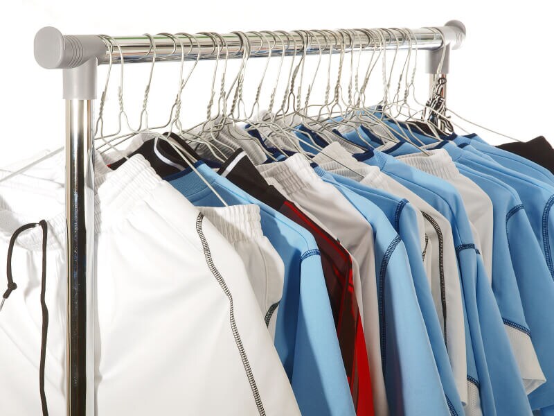 A rack of sports gear drying on hangers