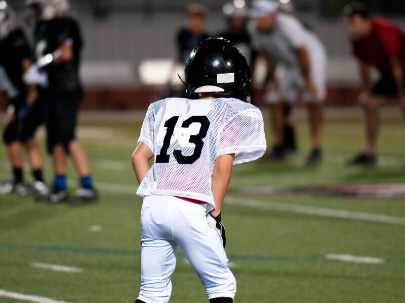 The back of a child in a football uniform