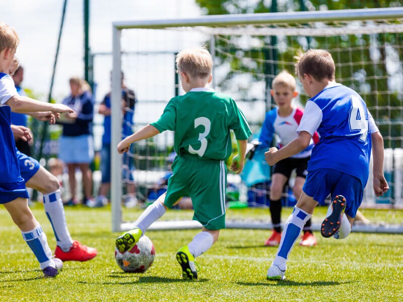 A group of children playing soccer
