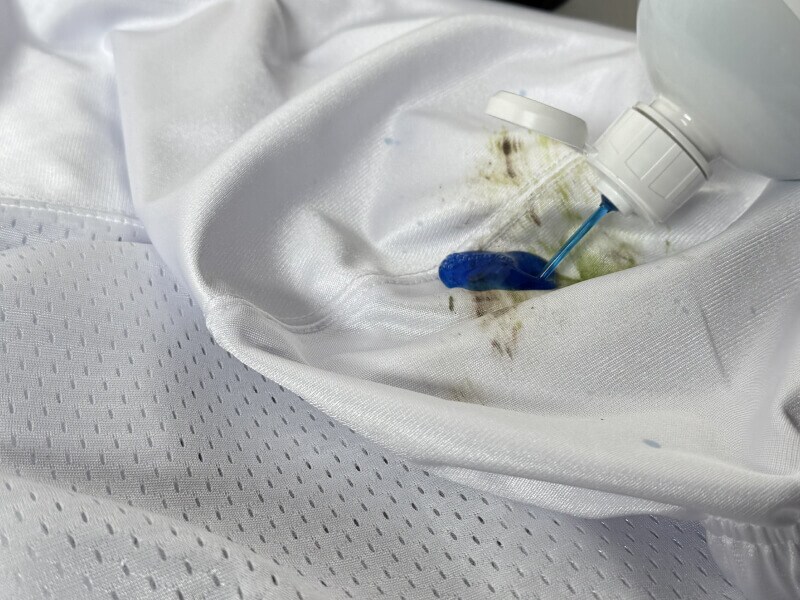 Cleaning solution being applied to a grass stain