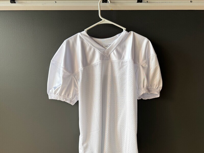 A jersey air drying on a hanger