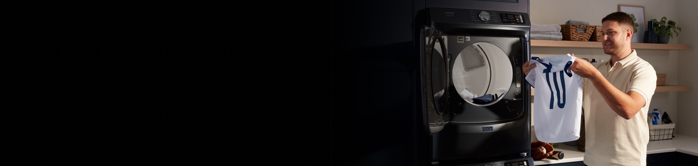 A person pulling a sports jersey out of the dryer