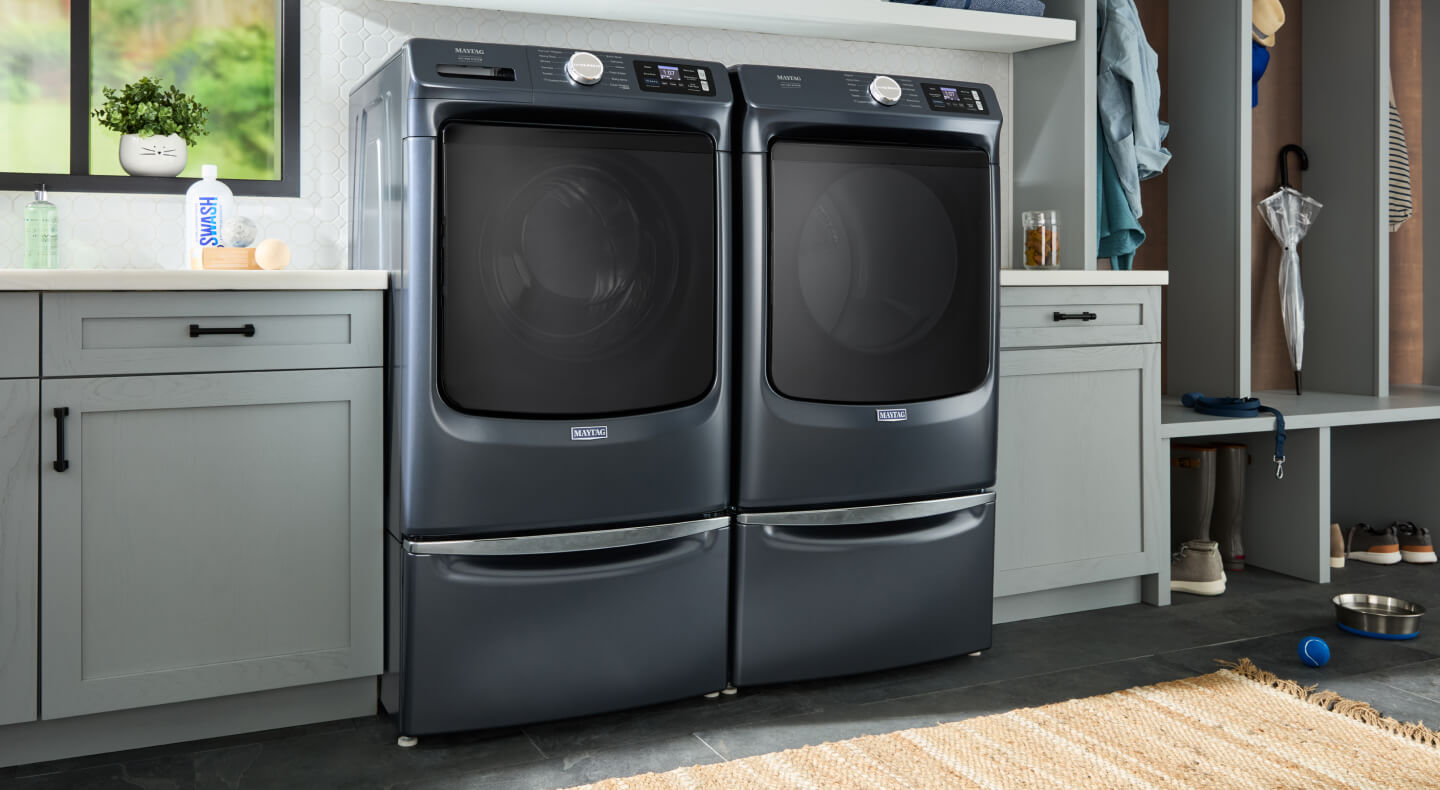 Maytag® front load washer and dryer in a laundry room