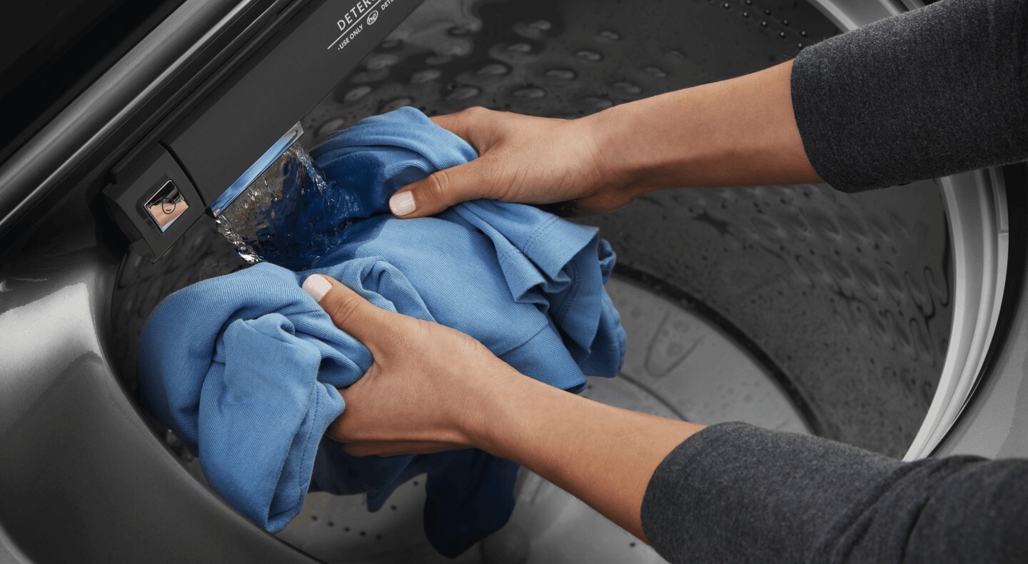 Person handwashing a garment Person handwashing a garment