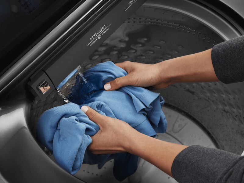 Person handwashing a garment Person handwashing a garment