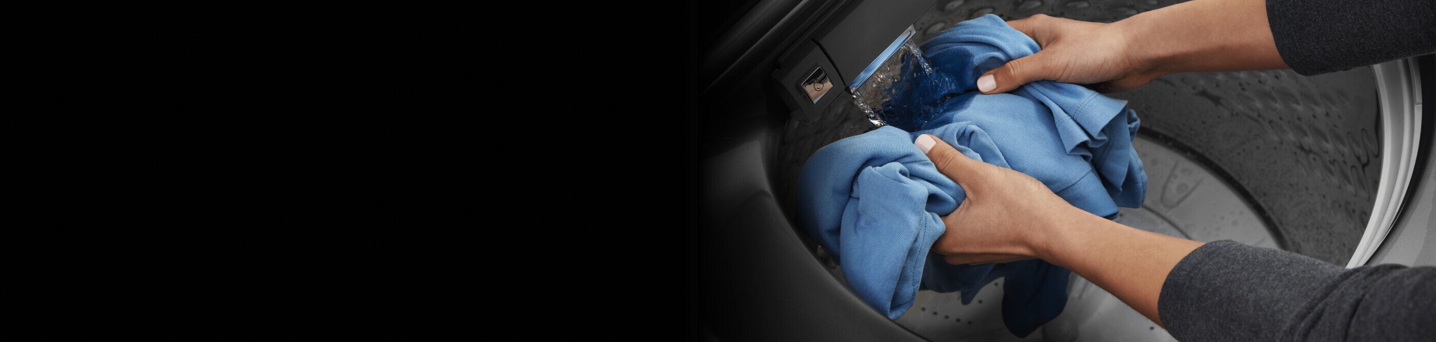 Person rinsing blue clothes in washing machine