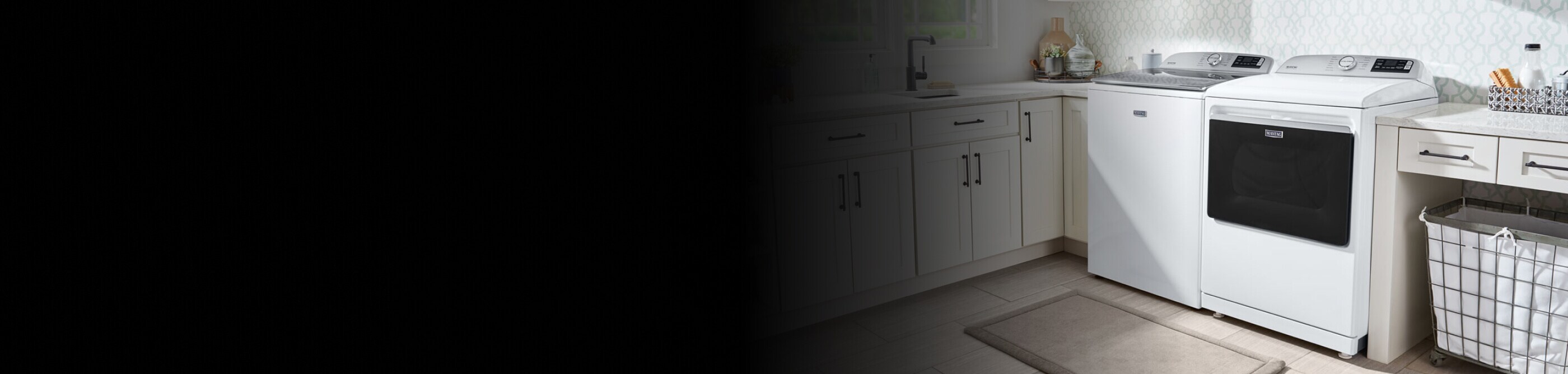 White Maytag® washer and dryer in a laundry room