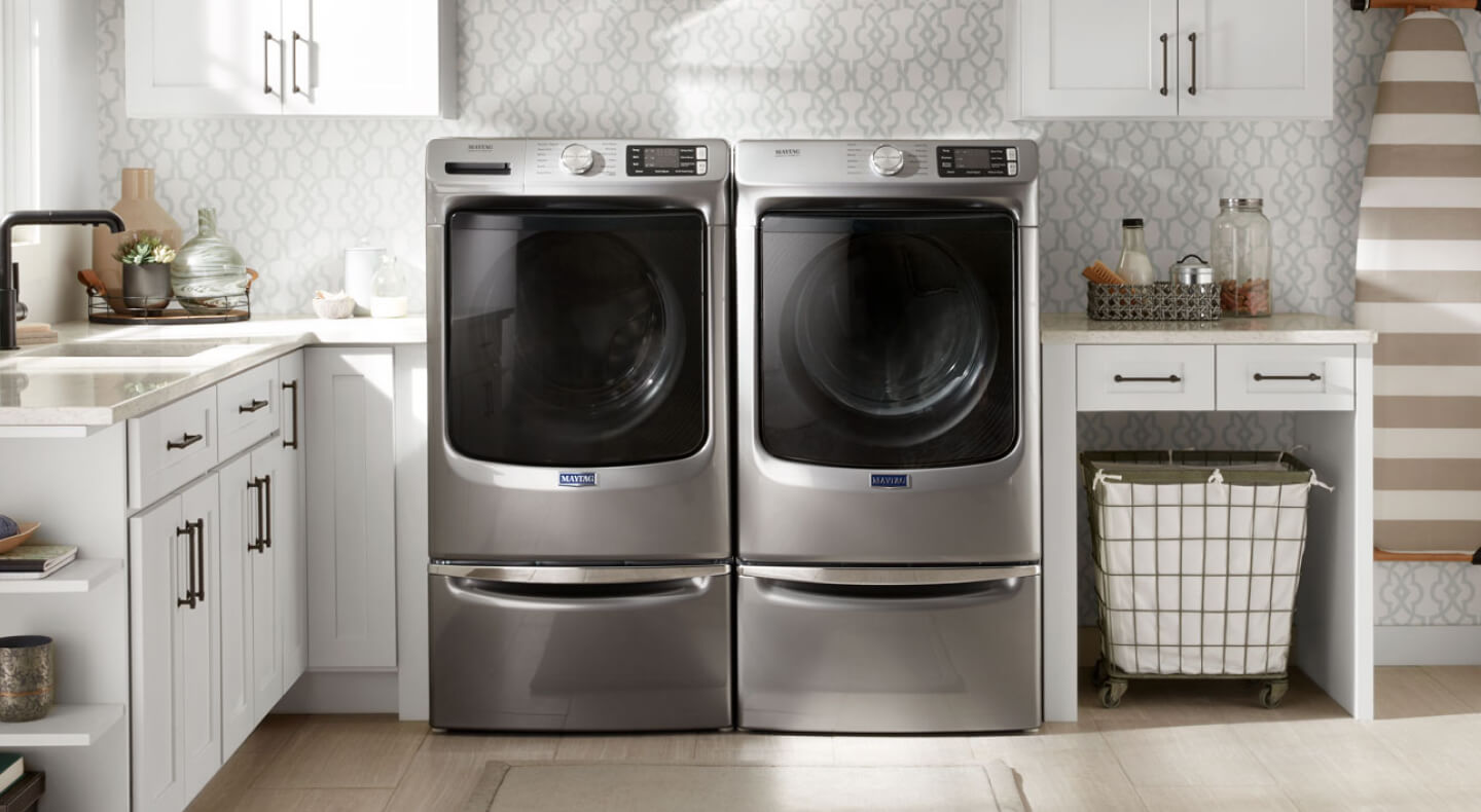 Maytag® front load washer and dryer set in a laundry room