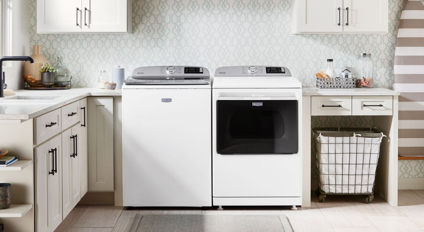 Maytag® top load washer and dryer in a laundry room