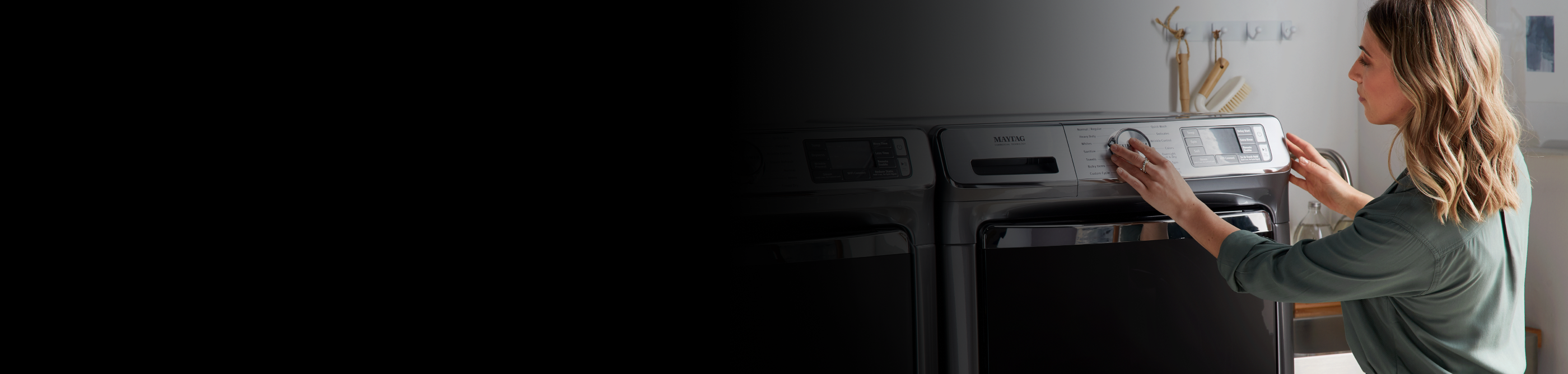 Person adjusting Maytag® dryer settings