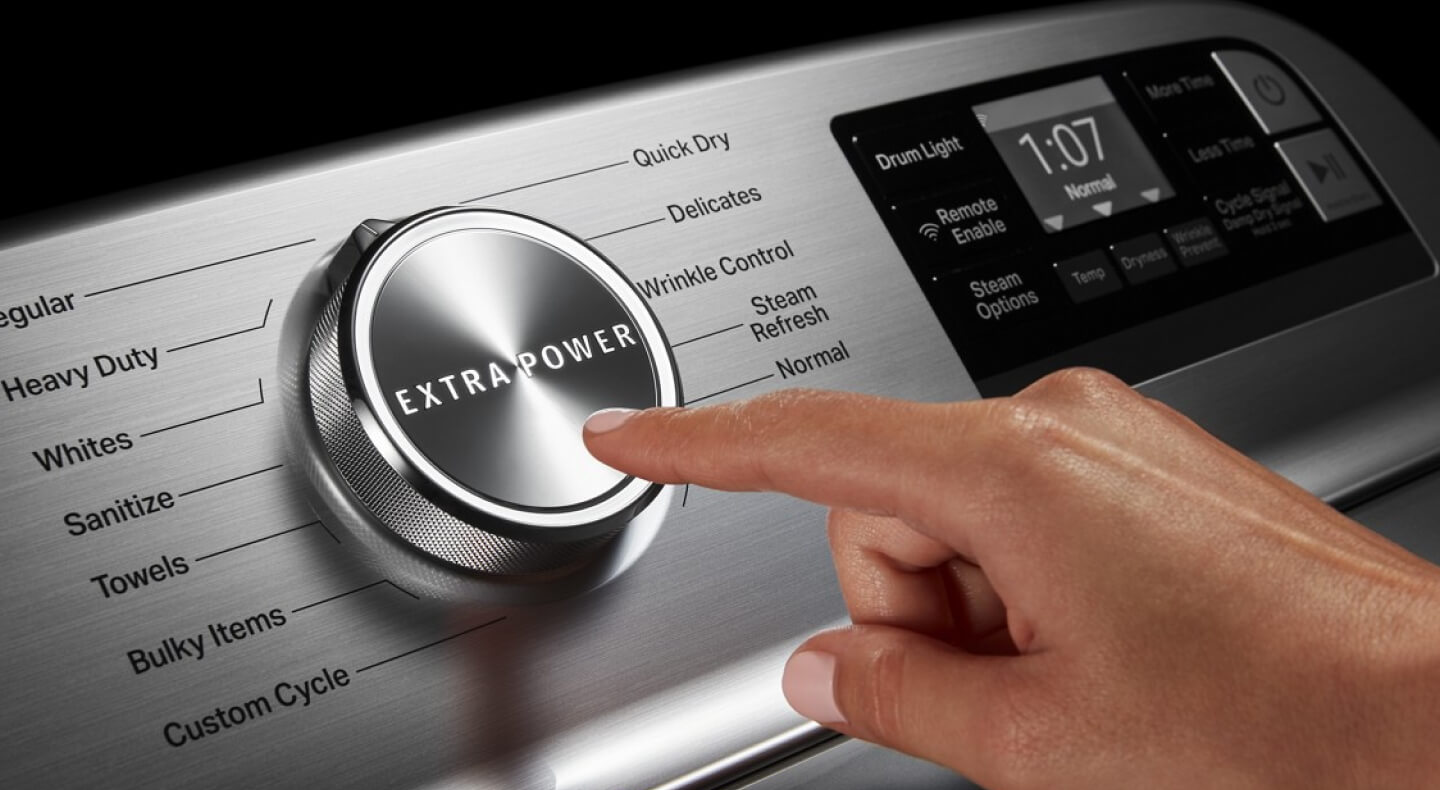 Close-up of person selecting the Extra Power Button on a Maytag® dryer
