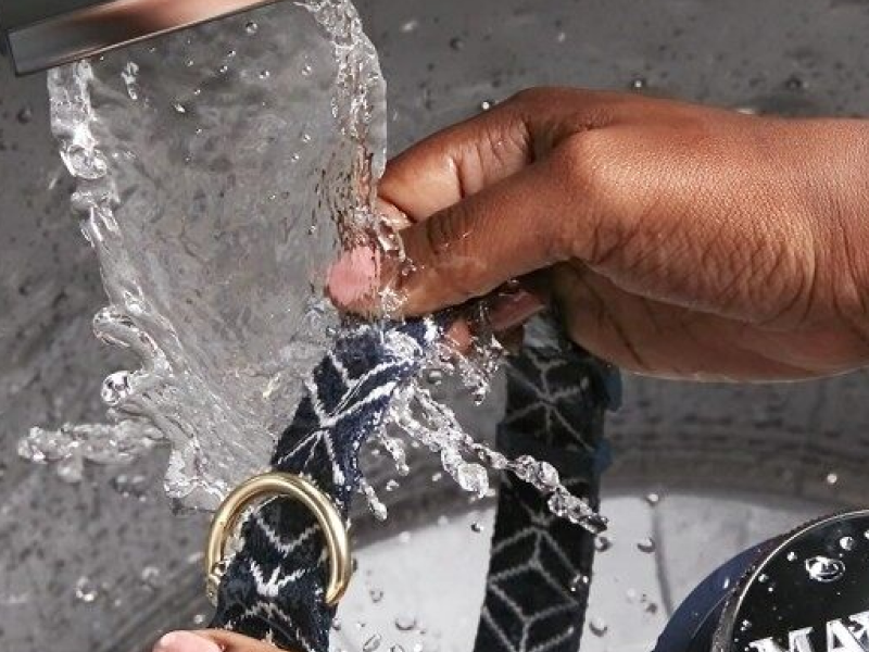 A person washing a collar in a Maytag® washer A person washing a collar in a Maytag® washer