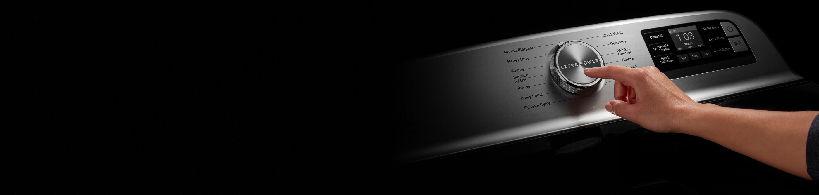 Person selecting a setting on a Maytag® washing machine